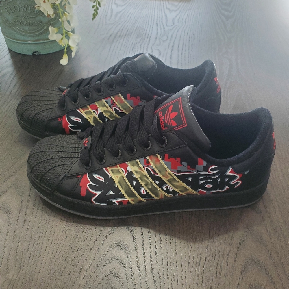 Adidas Black and Red Graphic Sneakers with Gold Accents